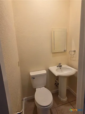 a white toilet sitting next to a bathroom sink