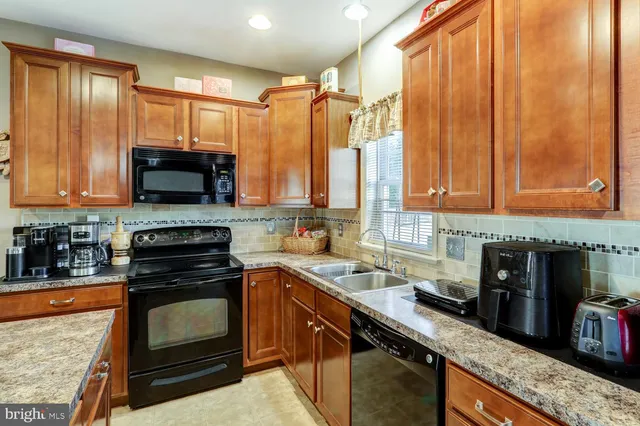 a kitchen with stainless steel appliances a stove a sink and a microwave