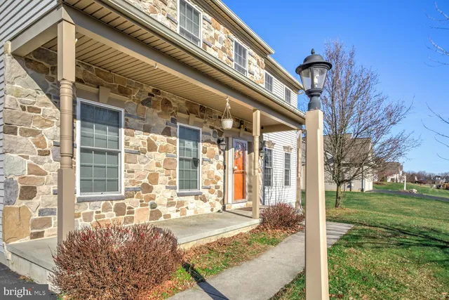 a front view of a building with a garden
