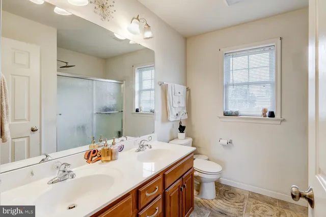 a bathroom with a sink double vanity and a mirror