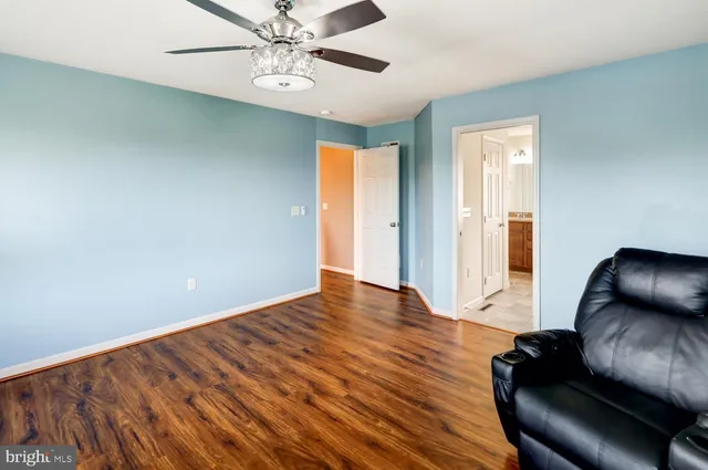 a spacious bathroom with a tub sink and mirror
