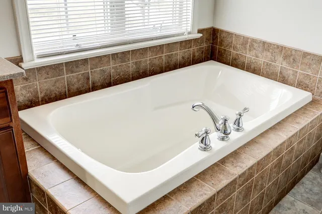 a bathroom with a sink a toilet and a shower