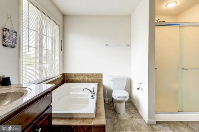 a bedroom with a bed and dresser with mirror