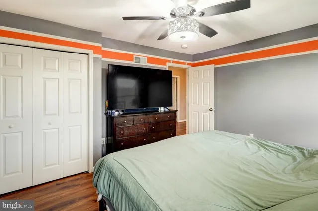 a bedroom with furniture and a flat screen tv