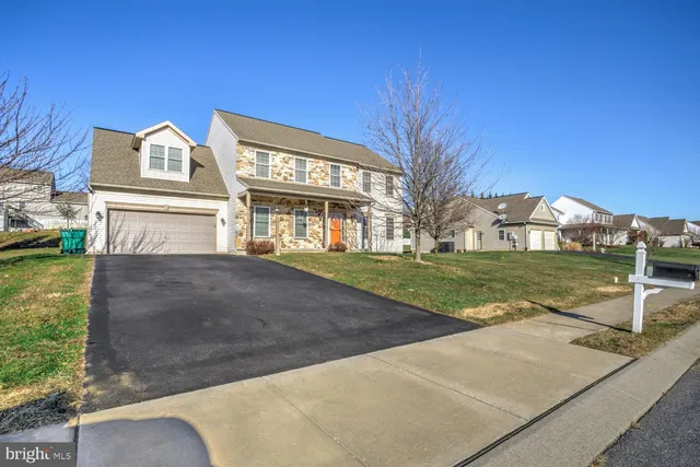 a front view of house with a garden