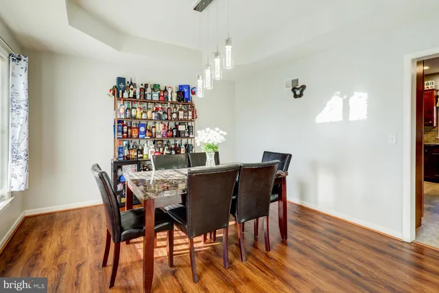 a dining room with furniture and wooden floor