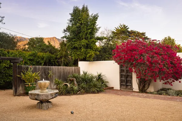 a view of a chairs and tables in the back yard of the house