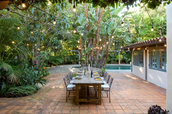 a view of a patio with table and chairs and potted plants
