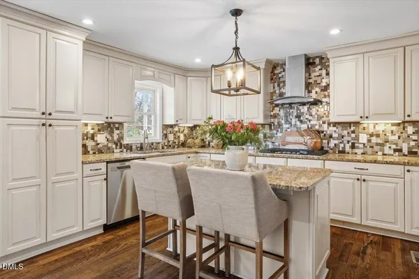 a kitchen with stainless steel appliances granite countertop kitchen island wooden cabinets and refrigerator