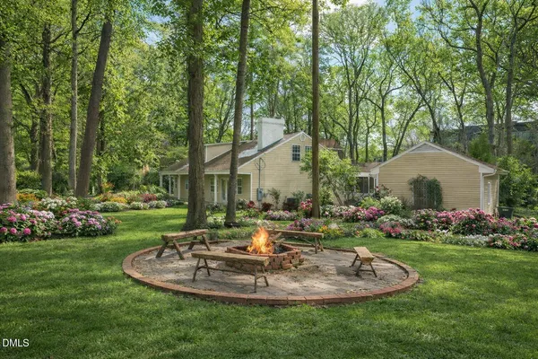 a view of a house with backyard and sitting area