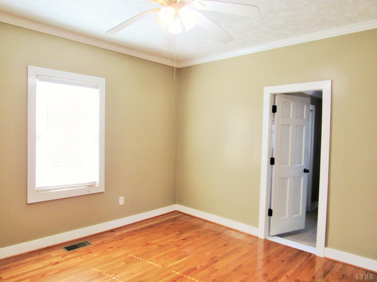 1697 South Amherst Highway Amherst, VA 24521 - Photo 14 of 45 a view of an empty room with wooden floor and a window