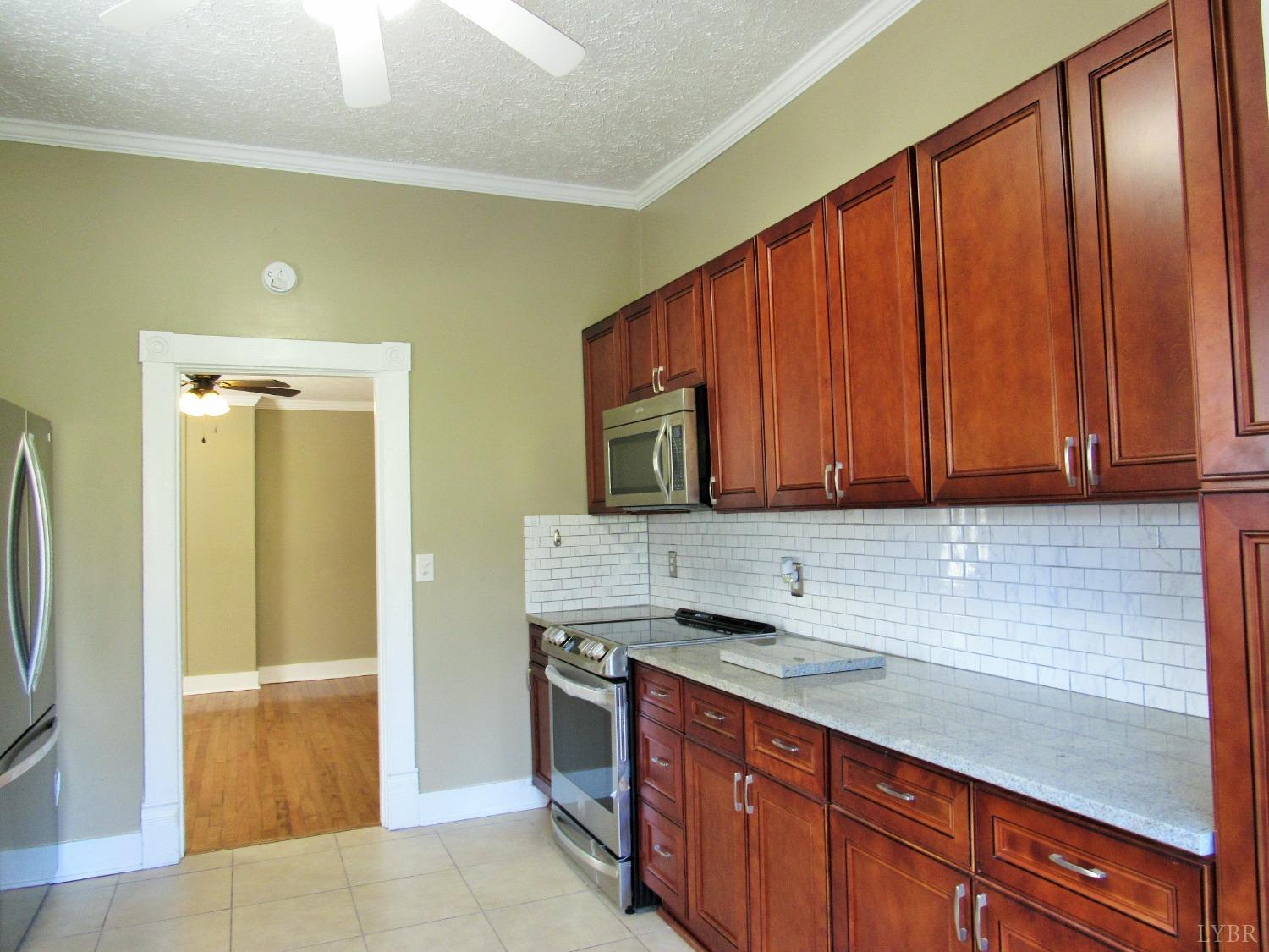 1697 South Amherst Highway Amherst, VA 24521 - Photo 22 of 45 a kitchen with stainless steel appliances granite countertop wooden cabinets a granite counter and a sink