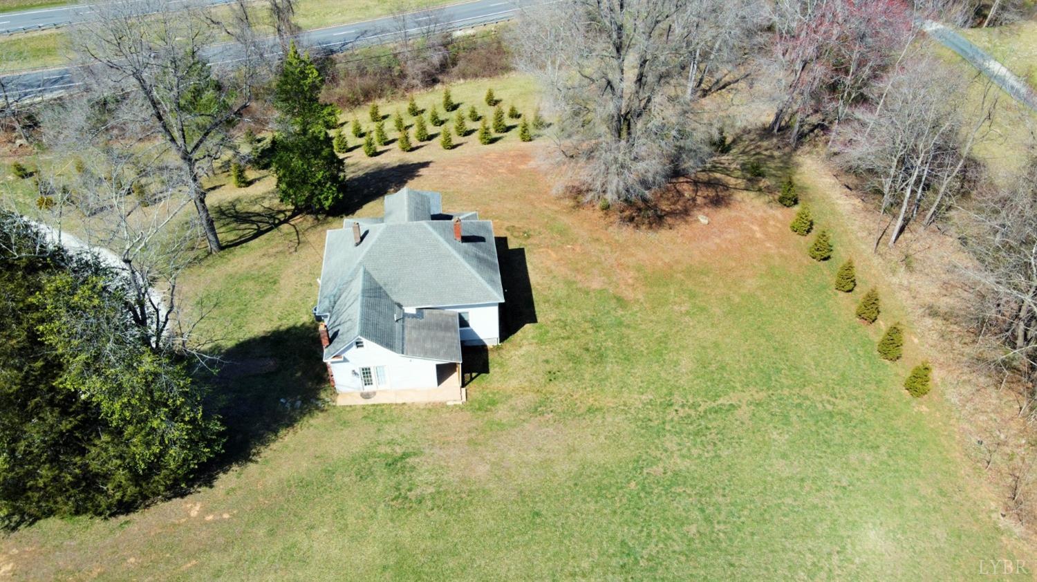 1697 South Amherst Highway Amherst, VA 24521 - Photo 44 of 45 a aerial view of a house with a yard and large trees