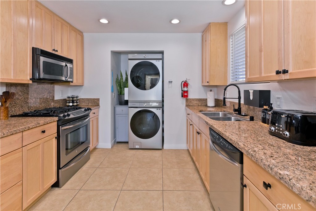 10510 Ocotillo Road Desert Hot Springs, CA 92240 - Photo 11 of 35 a kitchen with a stove top oven sink and cabinets