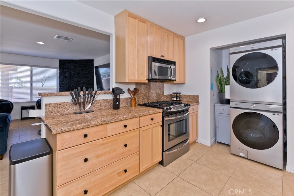 10510 Ocotillo Road Desert Hot Springs, CA 92240 - Photo 12 of 35 a kitchen with a sink a stove and cabinets