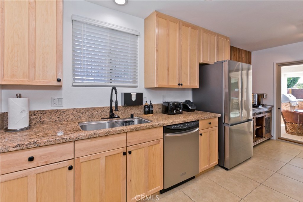 10510 Ocotillo Road Desert Hot Springs, CA 92240 - Photo 14 of 35 a kitchen with a sink stove and refrigerator