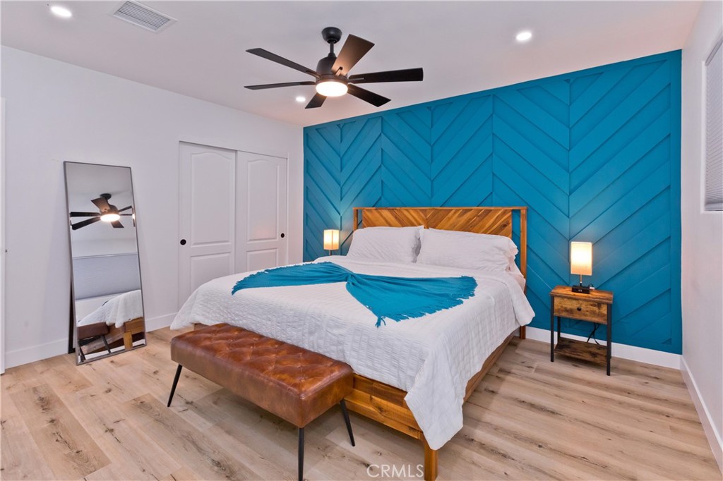 10510 Ocotillo Road Desert Hot Springs, CA 92240 - Photo 21 of 35 a bedroom with a bed and a chandelier