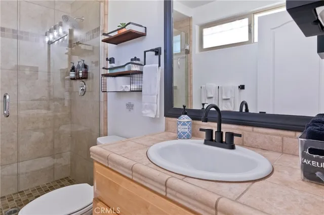 a view of a patio with a table and chairs under an umbrella