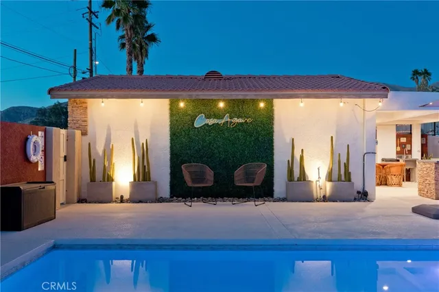 a kitchen with stainless steel appliances kitchen island granite countertop a sink a stove a dining table and chairs