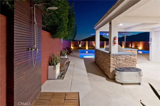 a view of a patio with table and chairs a fire pit