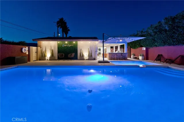 a bedroom with furniture and large windows