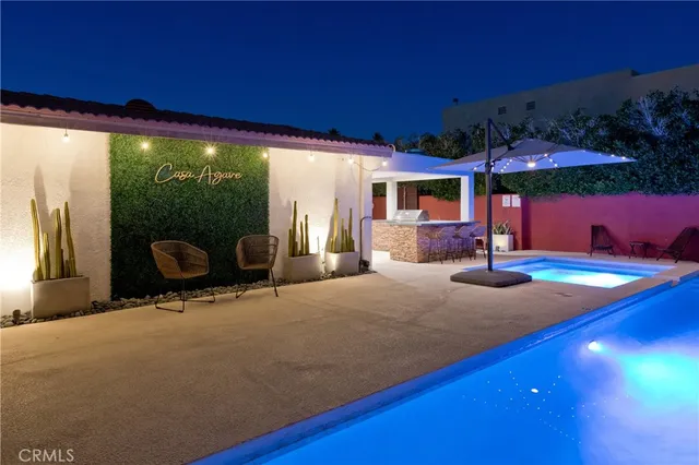 a living room with furniture pool table chairs and a fireplace