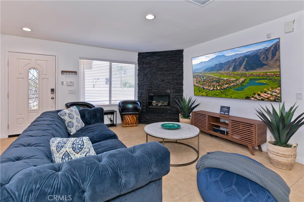 10510 Ocotillo Road Desert Hot Springs, CA 92240 - Photo 4 of 35 a living room with furniture and a flat screen tv
