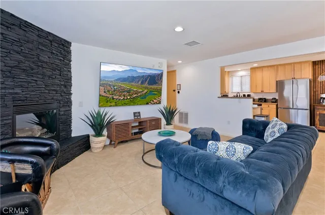 a living room with furniture and a fireplace