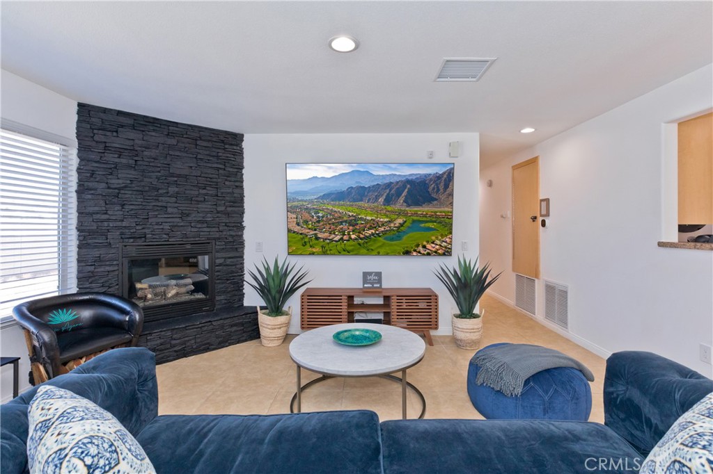 10510 Ocotillo Road Desert Hot Springs, CA 92240 - Photo 8 of 35 a living room with furniture and a fireplace