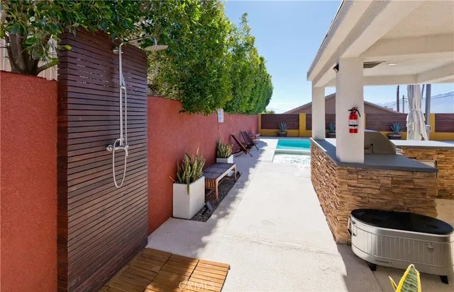 a yellow and red umbrella sitting in front of a house