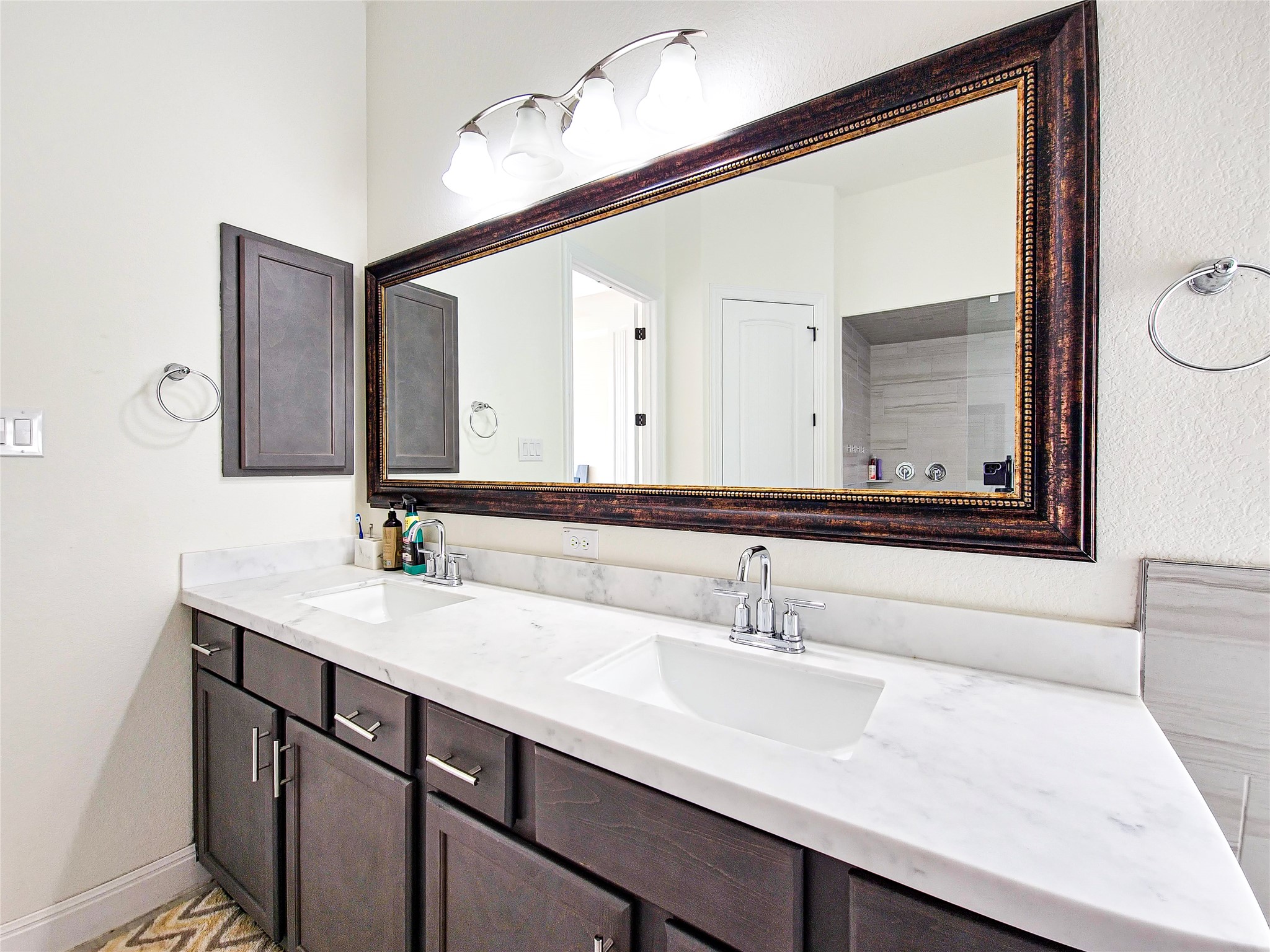 813 Sunny Ridge Drive Leander, TX 78641 - Photo 26 of 32 Double vanity with sleek marble countertops offers both elegance and practicality for daily routines.