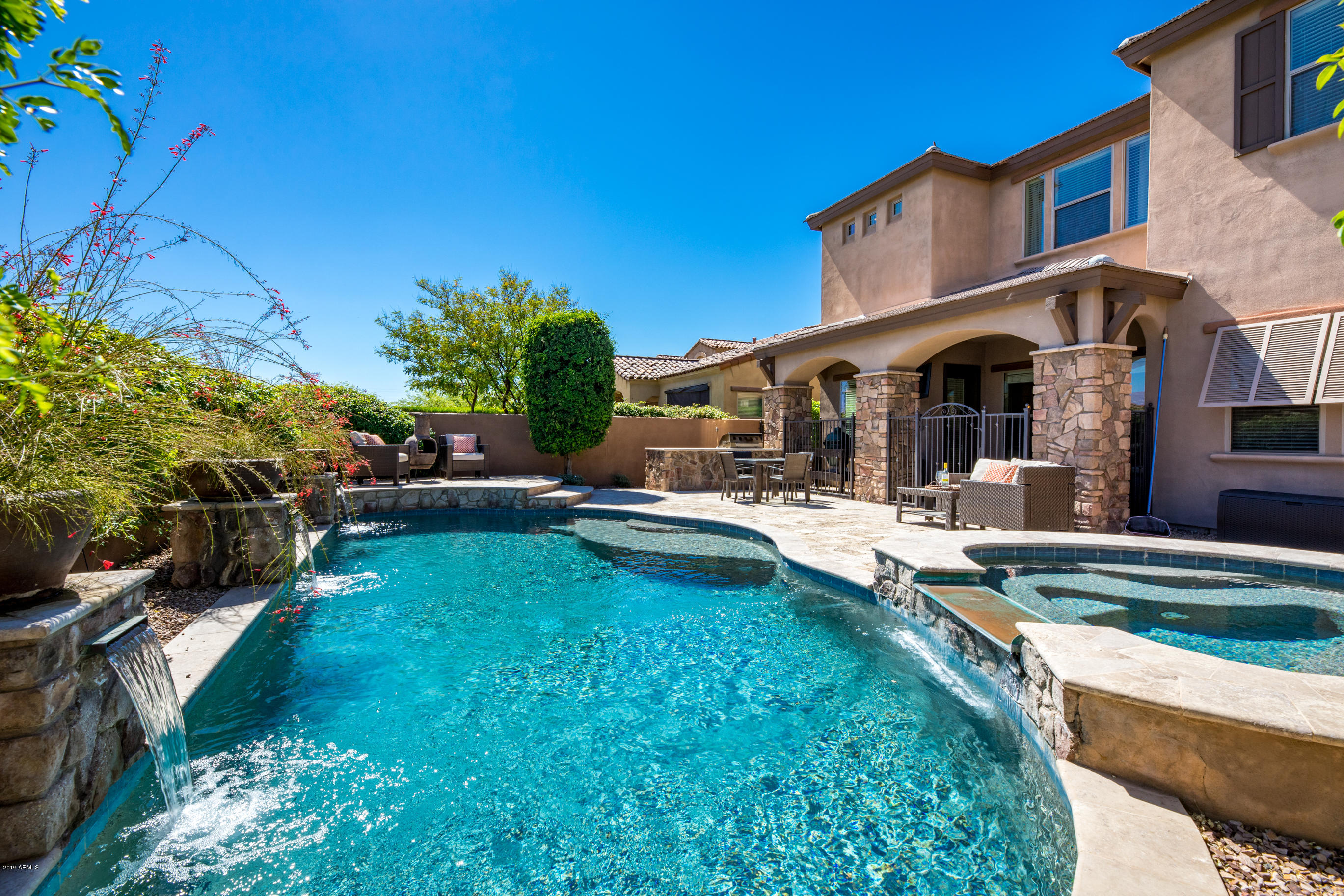 a view of a house with swimming pool and sitting area