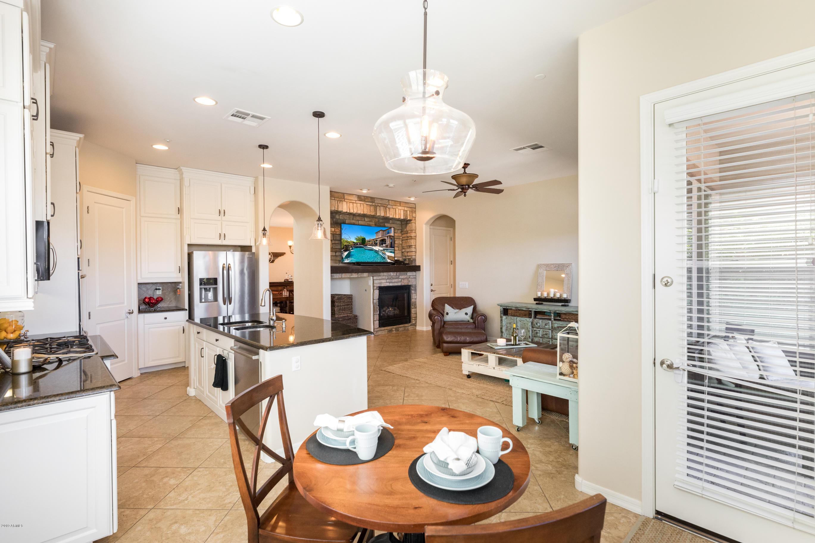 9185 East Canyon View Road Scottsdale, AZ 85255 - Photo 13 of 47 a kitchen with a dining table and chairs