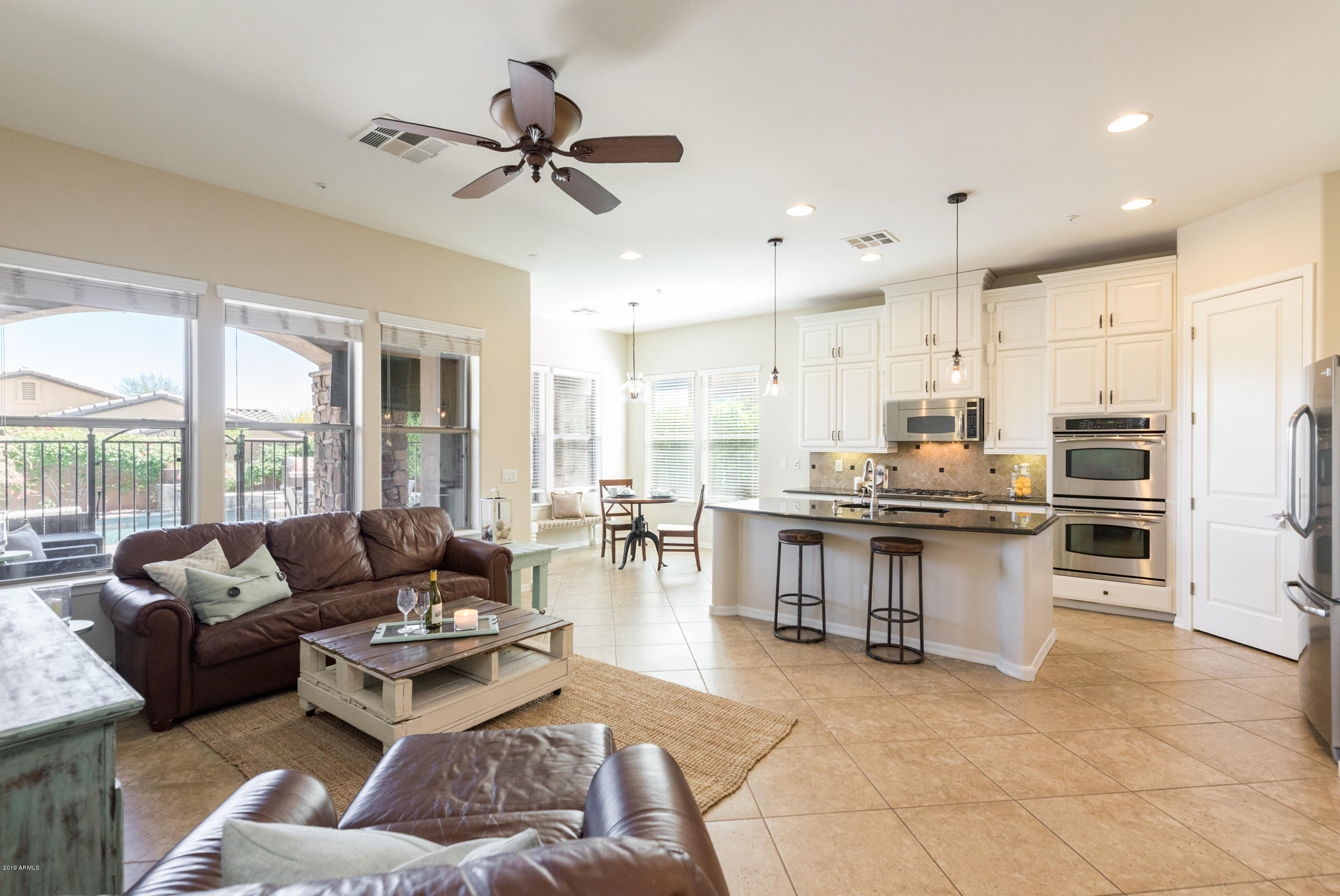 9185 East Canyon View Road Scottsdale, AZ 85255 - Photo 14 of 47 a living room with stainless steel appliances kitchen island granite countertop furniture and a view of kitchen