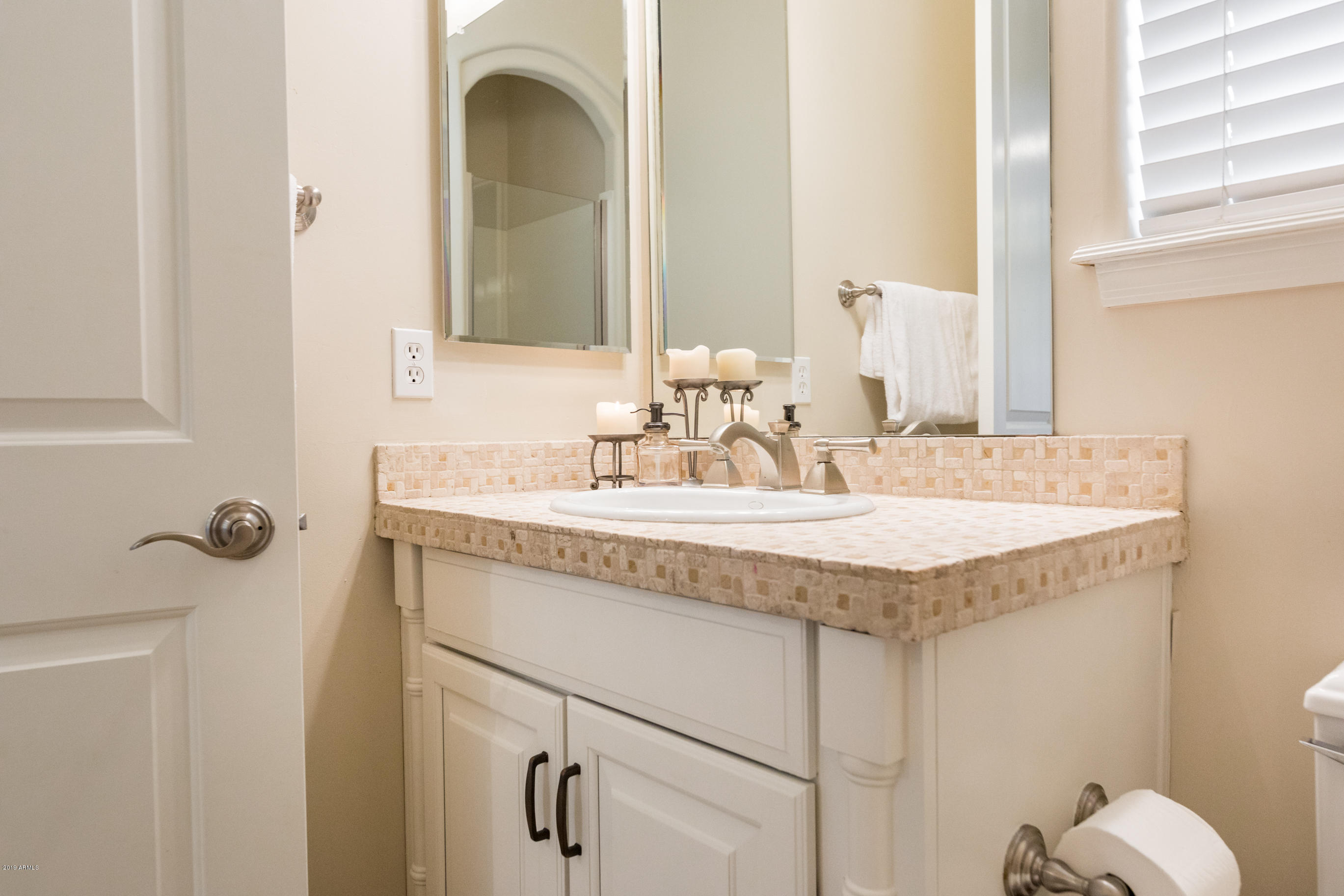 9185 East Canyon View Road Scottsdale, AZ 85255 - Photo 19 of 47 a bathroom with a granite countertop sink and a mirror