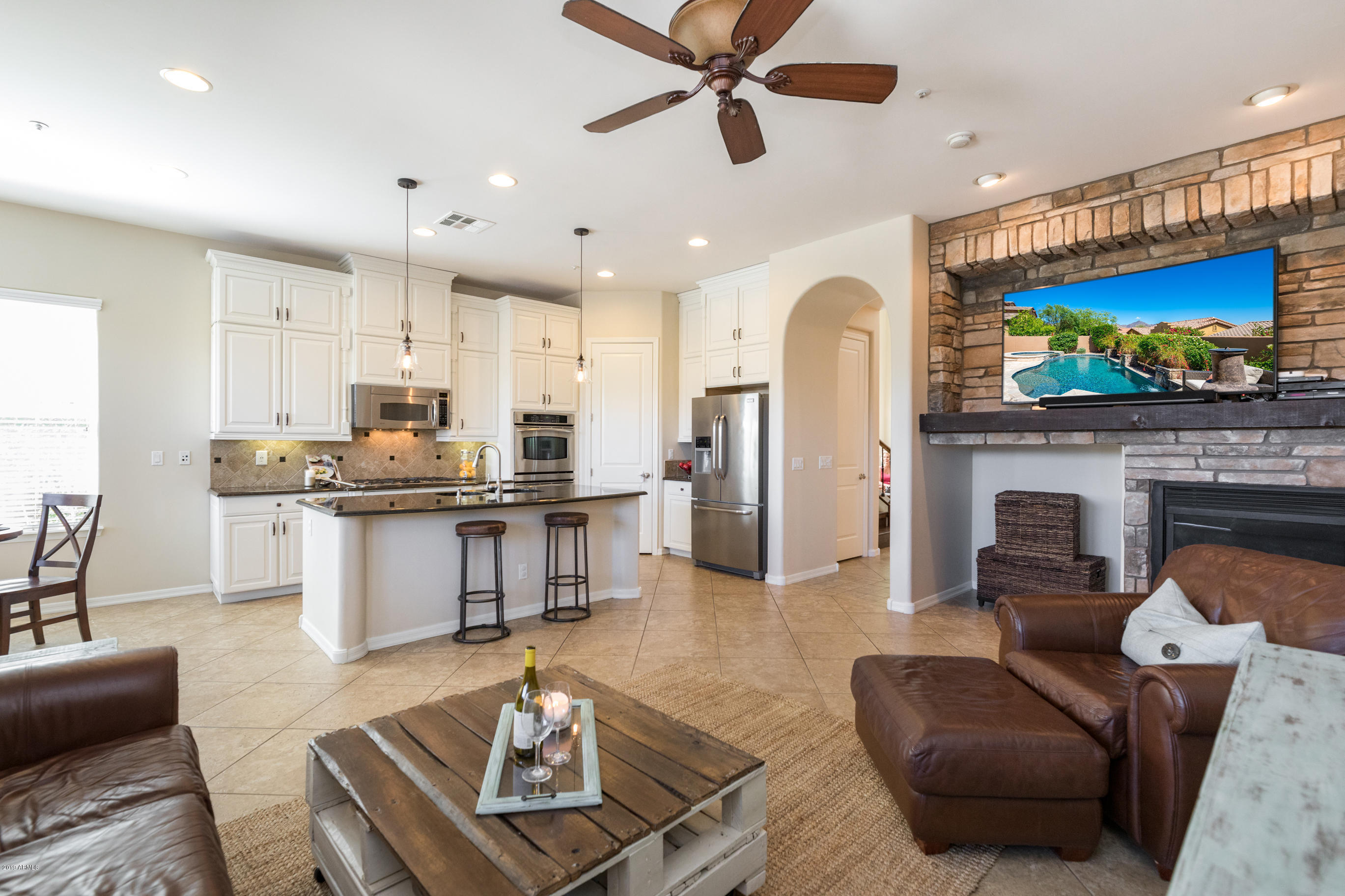 9185 East Canyon View Road Scottsdale, AZ 85255 - Photo 2 of 47 a living room with furniture and a fireplace