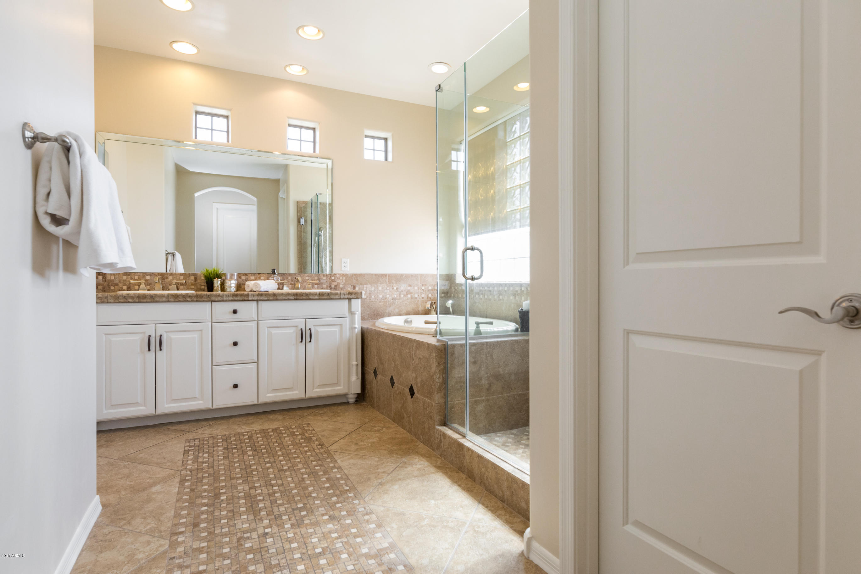 9185 East Canyon View Road Scottsdale, AZ 85255 - Photo 24 of 47 a bathroom with a sink a toilet and mirror