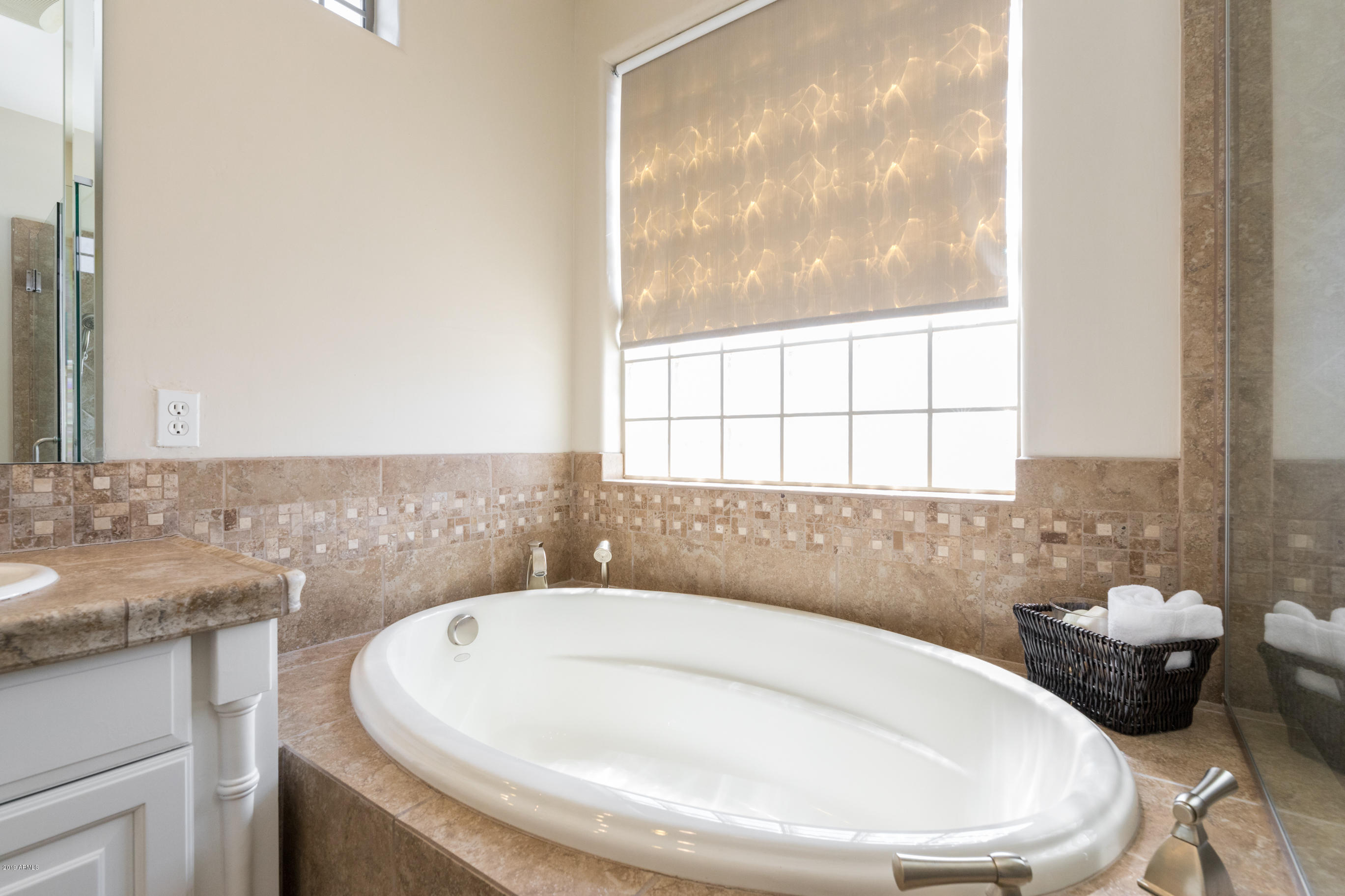 9185 East Canyon View Road Scottsdale, AZ 85255 - Photo 26 of 47 a bathroom with a granite countertop sink and a bathtub