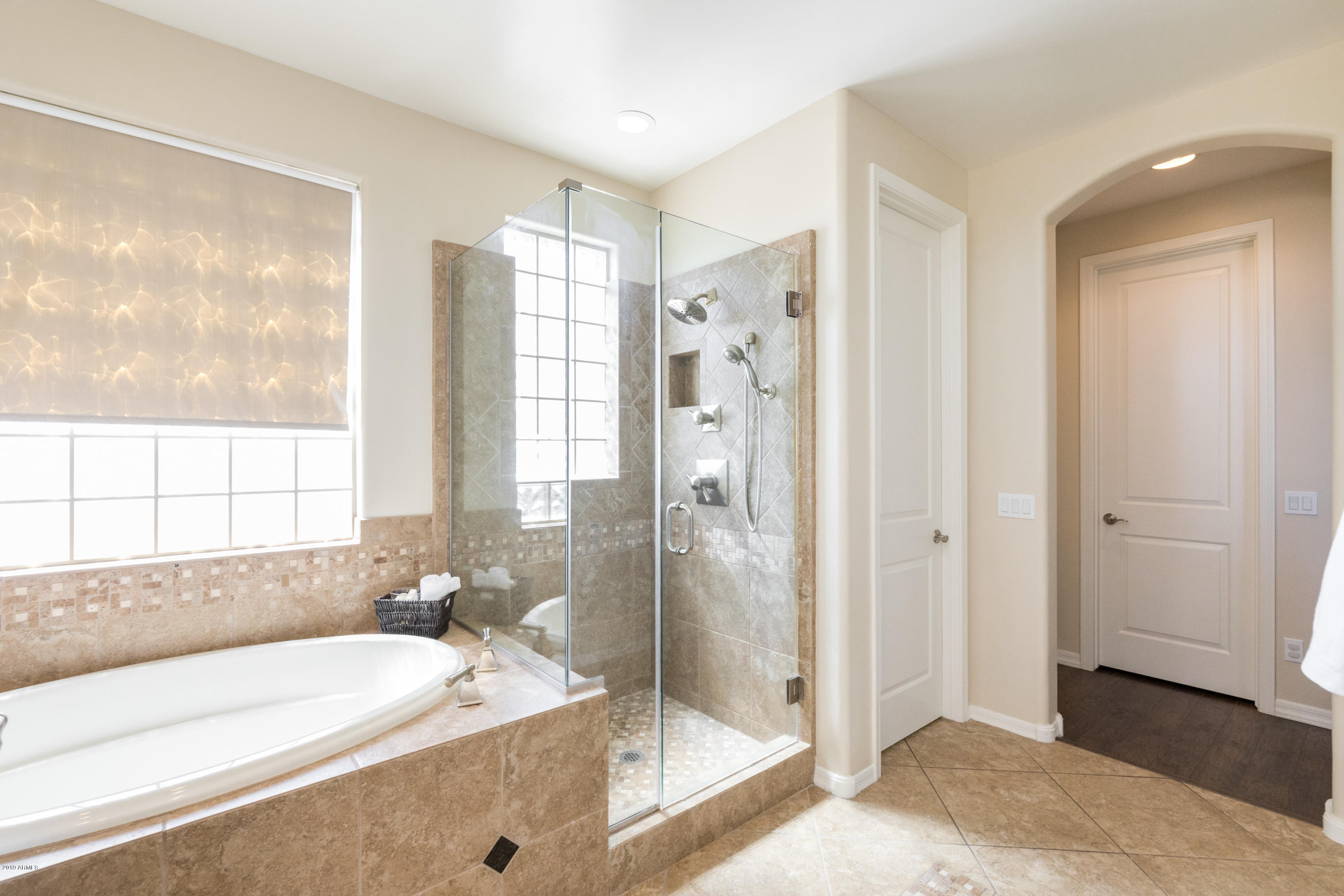 9185 East Canyon View Road Scottsdale, AZ 85255 - Photo 28 of 47 a bathroom with a tub sink and shower