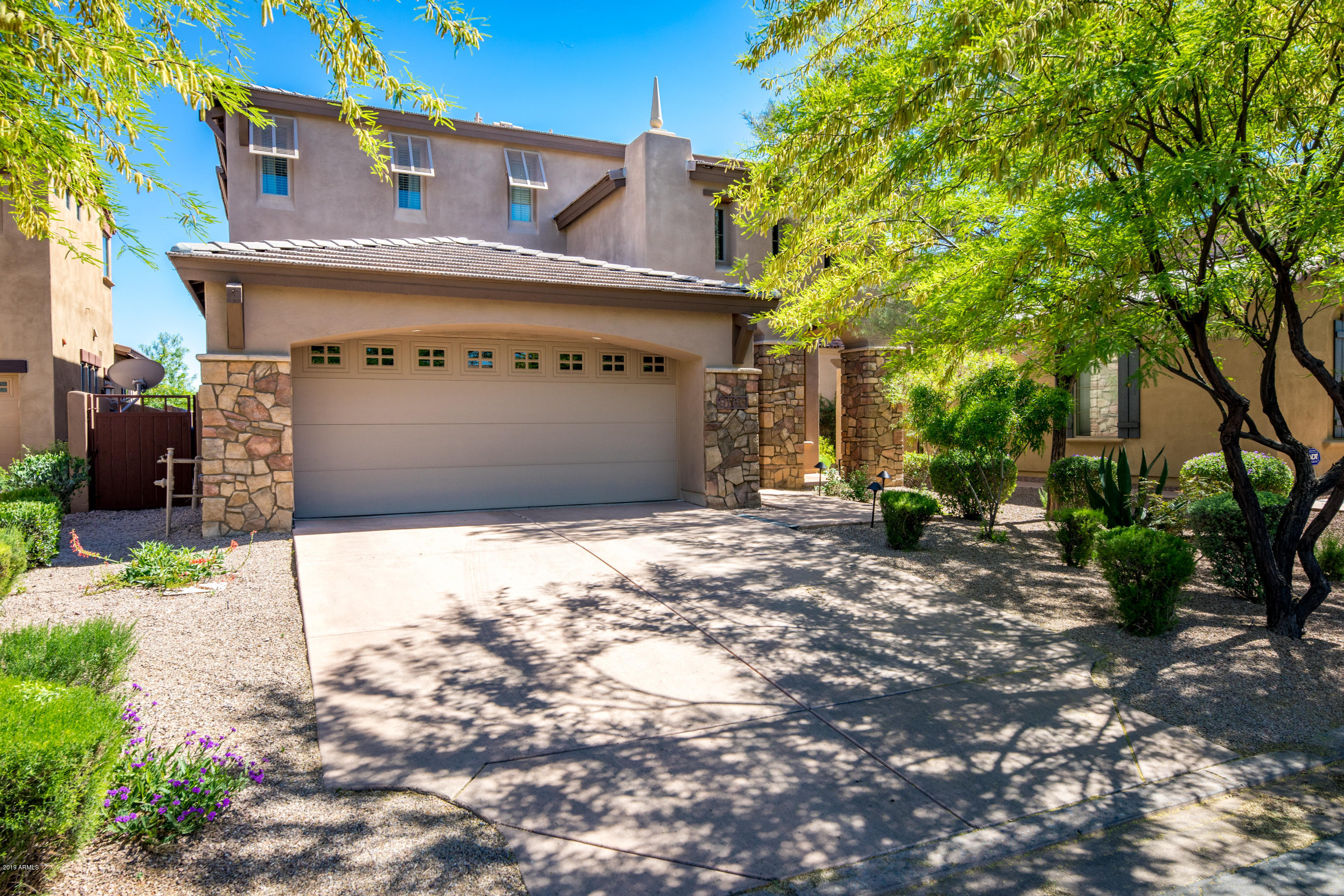 9185 East Canyon View Road Scottsdale, AZ 85255 - Photo 3 of 47 a front view of a house with a yard