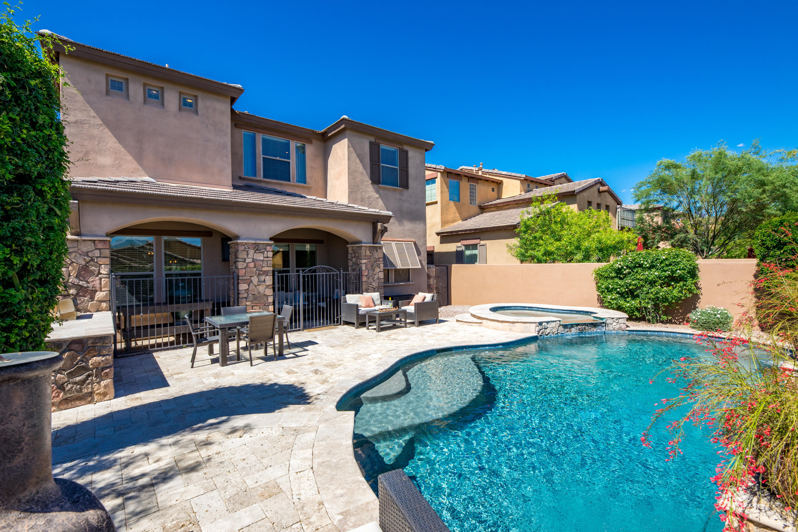 9185 East Canyon View Road Scottsdale, AZ 85255 - Photo 37 of 47 a view of a house with swimming pool and sitting area