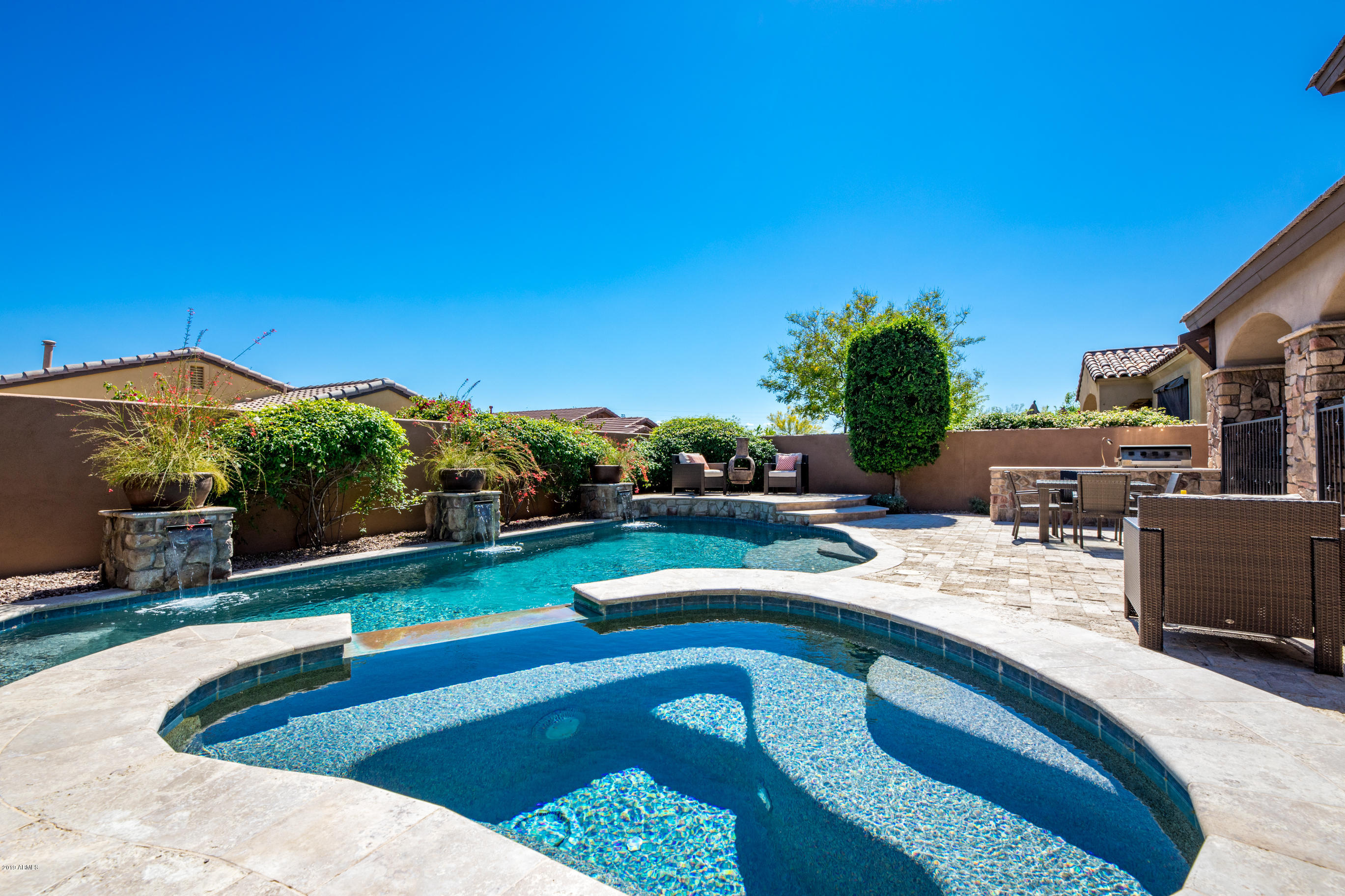 9185 East Canyon View Road Scottsdale, AZ 85255 - Photo 38 of 47 a view of a swimming pool with a patio