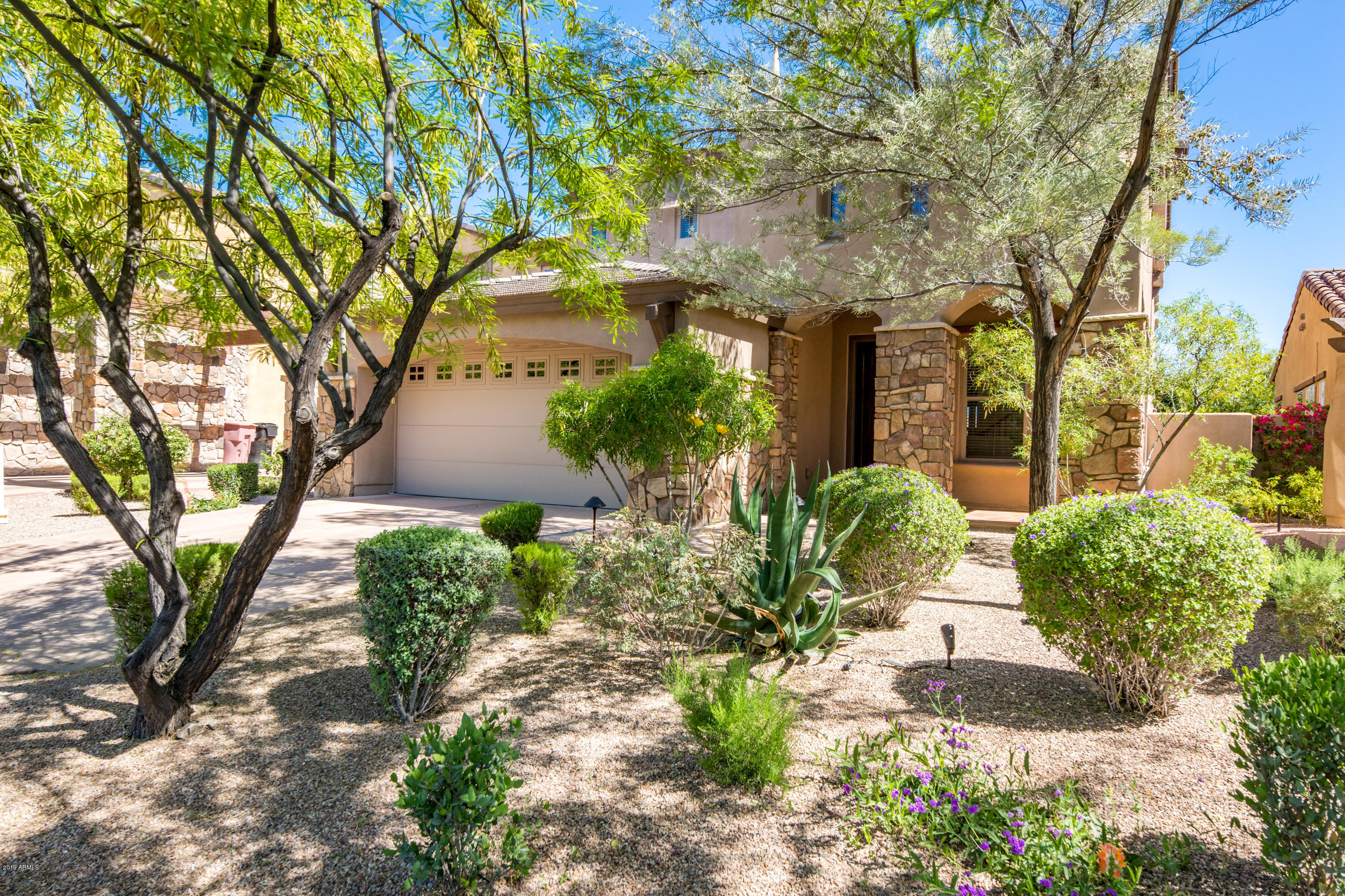 9185 East Canyon View Road Scottsdale, AZ 85255 - Photo 4 of 47 a front view of a house with garden