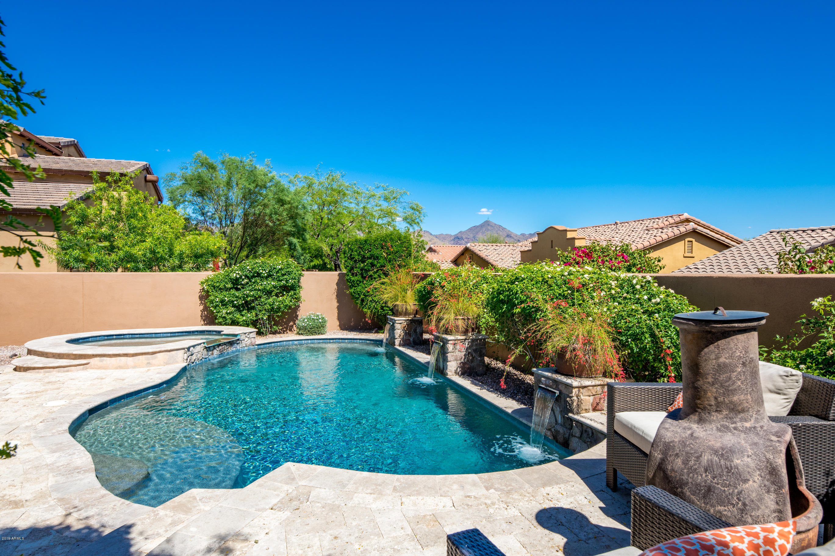 9185 East Canyon View Road Scottsdale, AZ 85255 - Photo 41 of 47 a view of a swimming pool with a patio