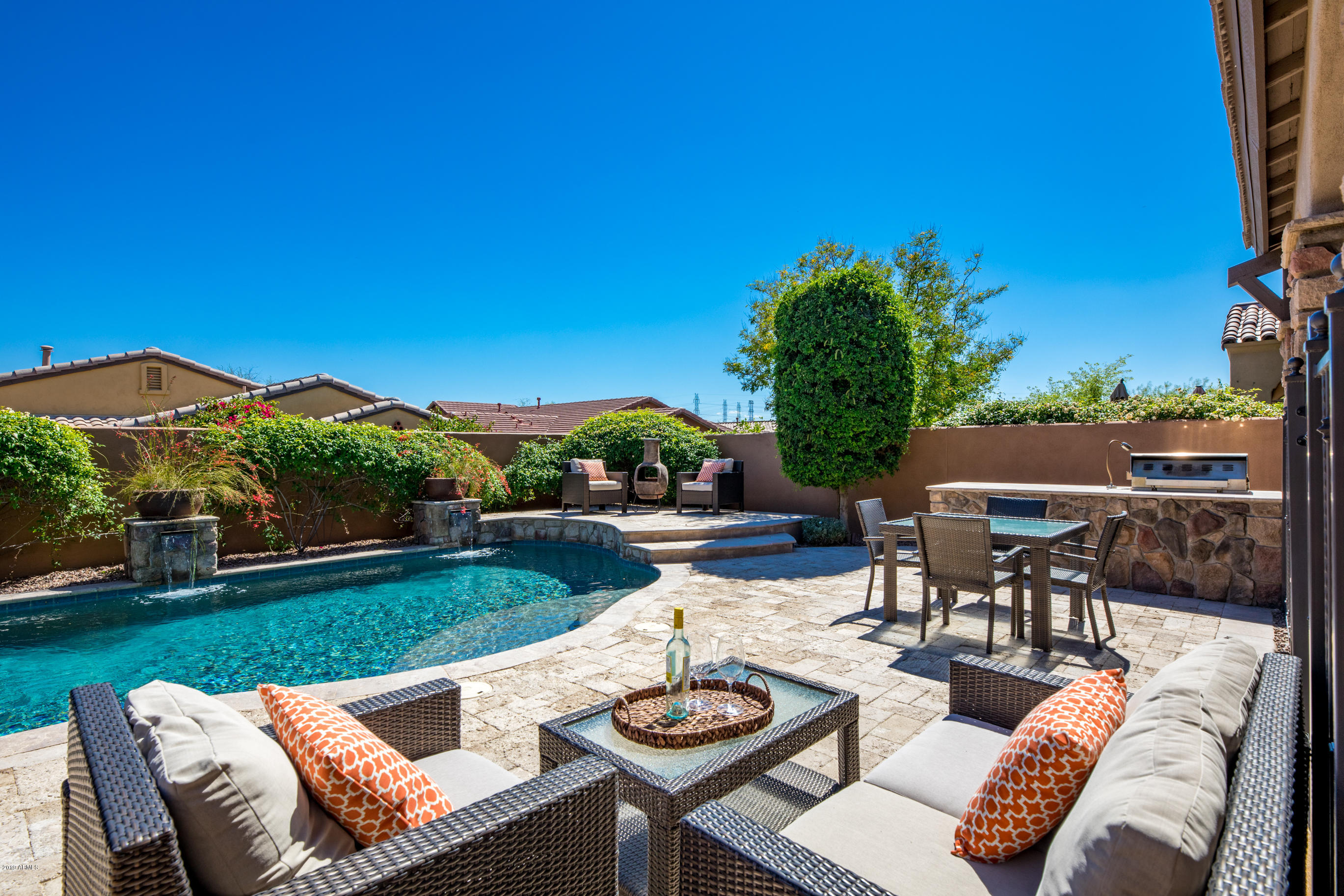 9185 East Canyon View Road Scottsdale, AZ 85255 - Photo 42 of 47 a view of a patio with couches table and chairs with garden