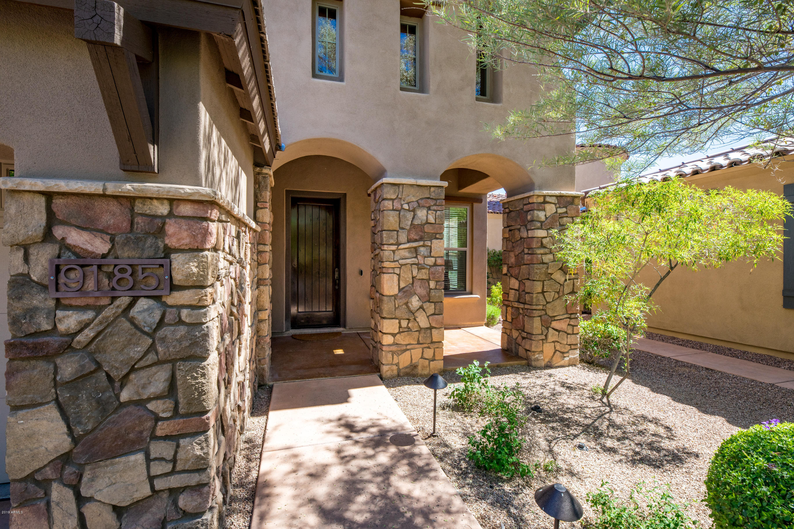 9185 East Canyon View Road Scottsdale, AZ 85255 - Photo 5 of 47 a front view of a house with a yard