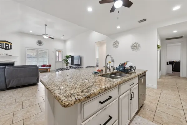 a bathroom with a granite countertop sink a large mirror and a shower