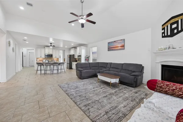 a living room with furniture and kitchen view