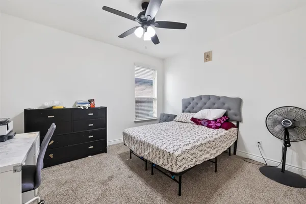 a bedroom with a bed and window