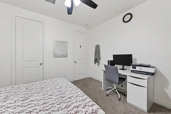 a bedroom with a workspace